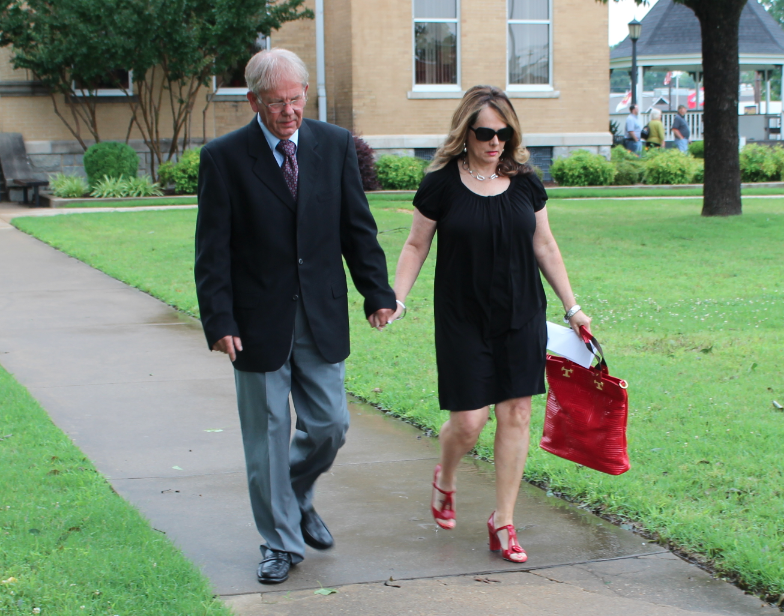 Former Saline County Sheriff Bruce Pennington leaves the Saline County Courthouse alongside his wife, Barbara Pennington, after pleading not guilty to charges filed against him last month.