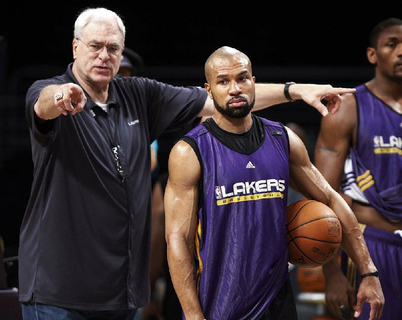 Little Rock’s Derek Fisher (right) and Phil Jackson, shown in 2010, won five NBA titles together with the Los Angeles Lakers. Reports indicate Jackson, now president of the New York Knicks, will hire Fisher as head coach today.