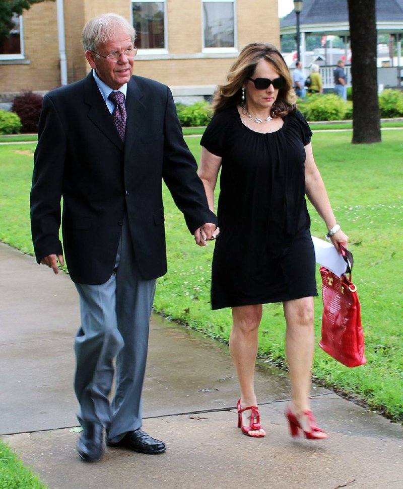 Former Saline County Sheriff Bruce Pennington leaves the Saline County Courthouse on Monday with his wife, Barbara, after pleading innocent to felony charges of abuse of public trust and theft of property as well as a misdemeanor.