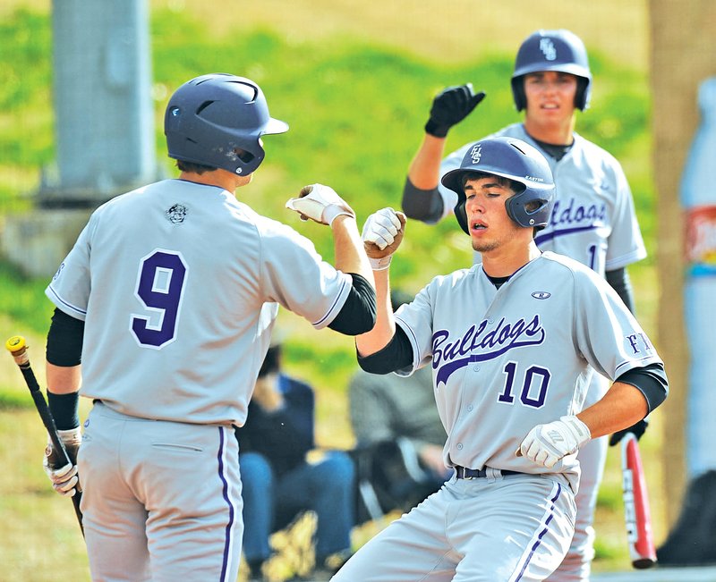 FILE PHOTO ANDY SHUPE Cody Davenport, right, of Fayetteville celebrates April 1 with Drew Tyler, left, after Davenport hit a solo home run against Rogers High during the second inning in Fayetteville. Davenport, Tyler and Andy Pagnozzi have been selected from Fayetteville for the 2014 Perfect Game National Showcase.