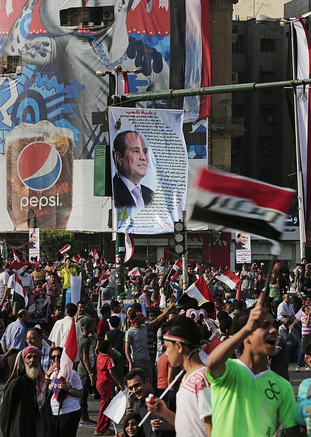 Supporters of Egyptian President Abdel-Fattah el-Sissi celebrate his inauguration Sunday in Cairo’s Tahrir Square. Egyptian police on Monday arrested seven men for sexually assaulting a 19-yearold student during the rally.