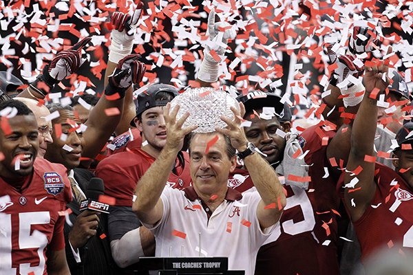In this Jan. 9, 2012 file photo, Alabama head football coach Nick Saban celebrates with his team after the BCS National Championship college football game against LSU in New Orleans. (AP Photo/Gerald Herbert, File)