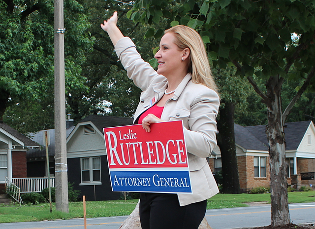 Attorney general candidate Leslie Rutledge waves to passing motorists while campaigning Tuesday morning in Little Rock.