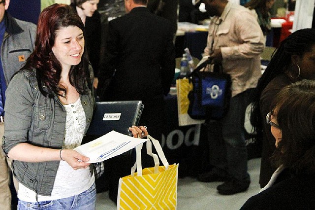 A job seeker (left) talks to a sales manager with Trillium Staffing at a job fair last month in Muskegon, Mich. Job openings in the U.S. climbed in April, the Labor Department said Tuesday.