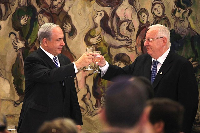 Newly elected Israeli president Reuven Rivlin (right) raises a toast Tuesday with Israeli Prime Minister Benjamin Netanyahu at the Knesset, Israel’s parliament, in Jerusalem.