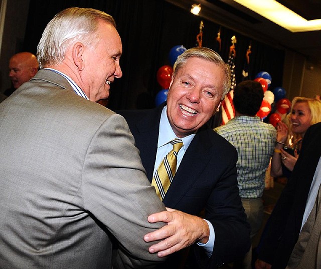 Sen. Lindsey Graham (right) is congratulated Tuesday night by his former college roommate, Billy Strickland, after winning the South Carolina Republican Senate primary.