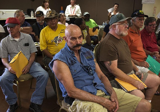 Dennis Dallacqua (front) waits with other veterans Tuesday at a crisis center set up at an American Legion post in Phoenix, a first-of-its-kind operation to tackle delays experienced at Veterans Affairs medical centers. The American Legion said it will operate the crisis center in Phoenix through Friday and expects to assist hundreds of veterans, possibly extending the program to other cities.