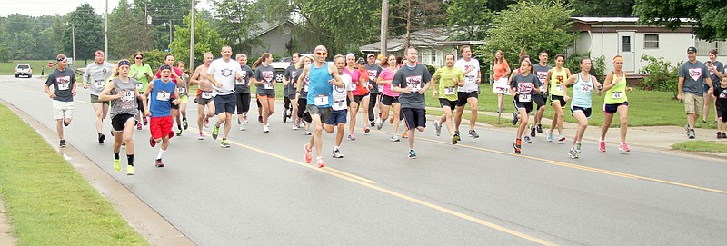 Photograph by Russ Wilson Participants in the 5K run recently for Community for a Cause raised money to help a former student, daughter of a former teacher, of Pea Ridge.