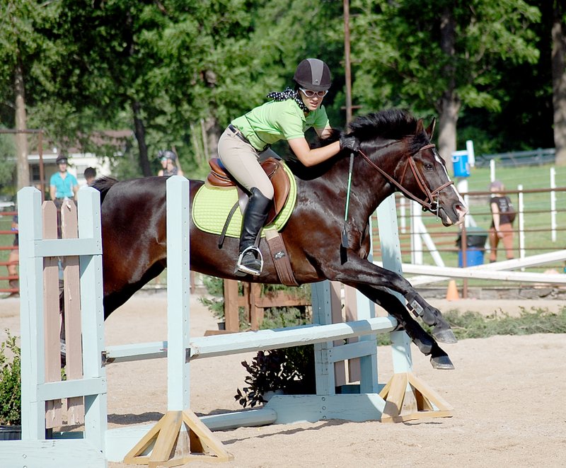 Photo by Janelle Jessen Meghan Raucher and Zack jumped a fence. The show included a 1950&#8217;s themed party on Saturday evening and competitors and spectators donned scarves and cat-eye glasses as part of the festivities.