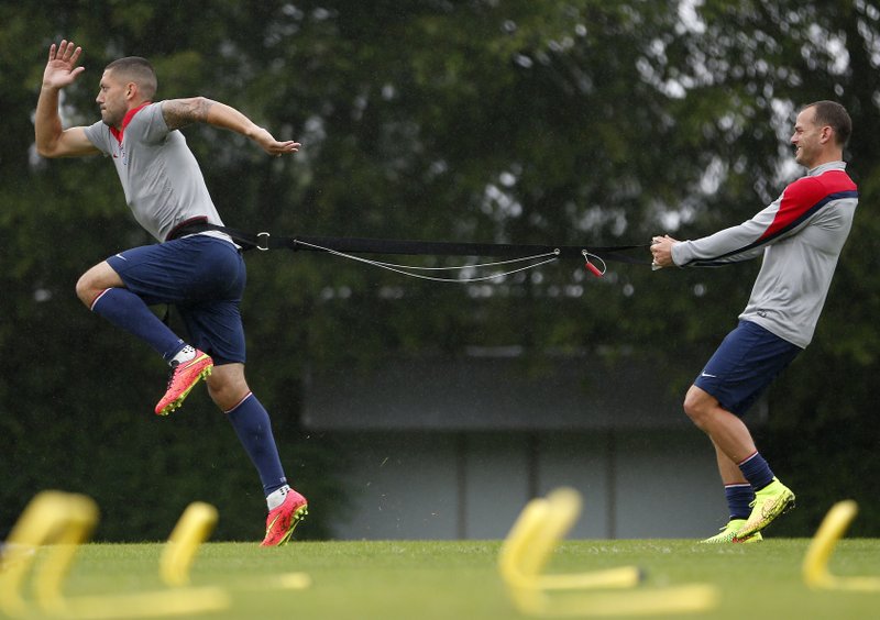 United States' Clint Dempsey, left, and Brad Davis work on resistance exercises during a training session at the Sao Paulo FC training center in Sao Paulo, Brazil, Tuesday, June 10, 2014. The U.S. will play in group G of the 2014 soccer World Cup.