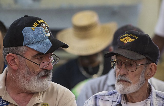Vietnam veteran Gene Stoesser, right, talks with Veterans Crisis Command Center volunteer Chuck Lewis, left, while he waits for an appointment Tuesday, June 10, 2014, at American Legion Post 1 in Phoenix. Stoesser was told on May 2, 2014, that he needs heart surgery. The American Legion has set up a crisis center in Phoenix to help veterans get medical care in a first-of-its-kind event in the American Legion's nearly 100-year history.