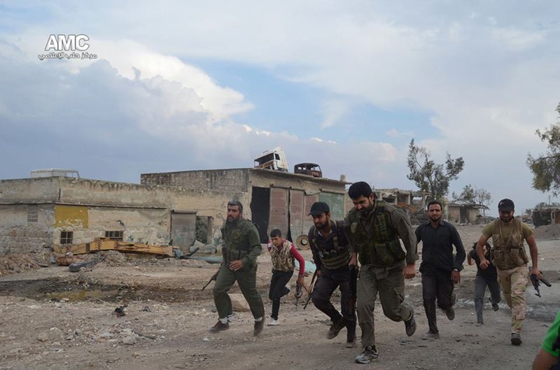 This photo provided by the anti-government activist group Aleppo Media Center (AMC), which has been authenticated based on its contents and other AP reporting, shows Free Syrian Army fighters running at one of the front lines in the town of Sheikh Najjar, in Aleppo, Syria, Tuesday June 10, 2014. Fighting in eastern Syria between Islamic rebel brigades and an al-Qaida splinter group has killed more than 630 people and uprooted at least 130,000 since the end of April, an activist group said Tuesday. 