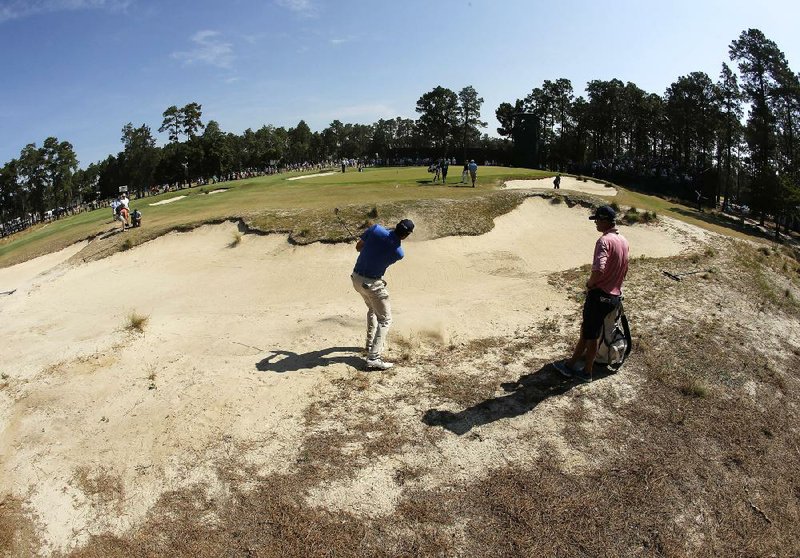 Matt Kuchar hits out of a bunker on No. 12 during a practice round Wednesday in Pinehurst, N.C. The U.S. Open usually has tight fairways and thick rough, but Pinehurst has plenty of room off the tees and no rough, just areas of sand and native grasses.