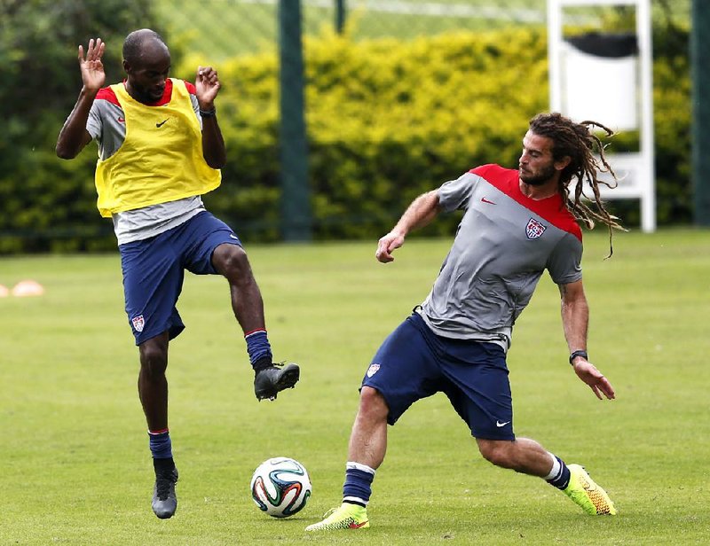 DeMarcus Beasley (left) and Kyle Beckerman compete for a ball during the U.S. team’s practice Wednesday in Sao Paulo. The United States opens World Cup play Monday against Ghana.