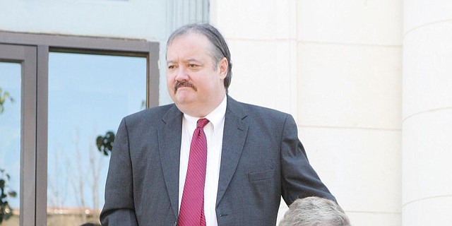 Former Ouachita County Judge Mike Hesterly leaves federal court on June 11, 2014, in El Dorado with his mother, Mamie Hesterly.