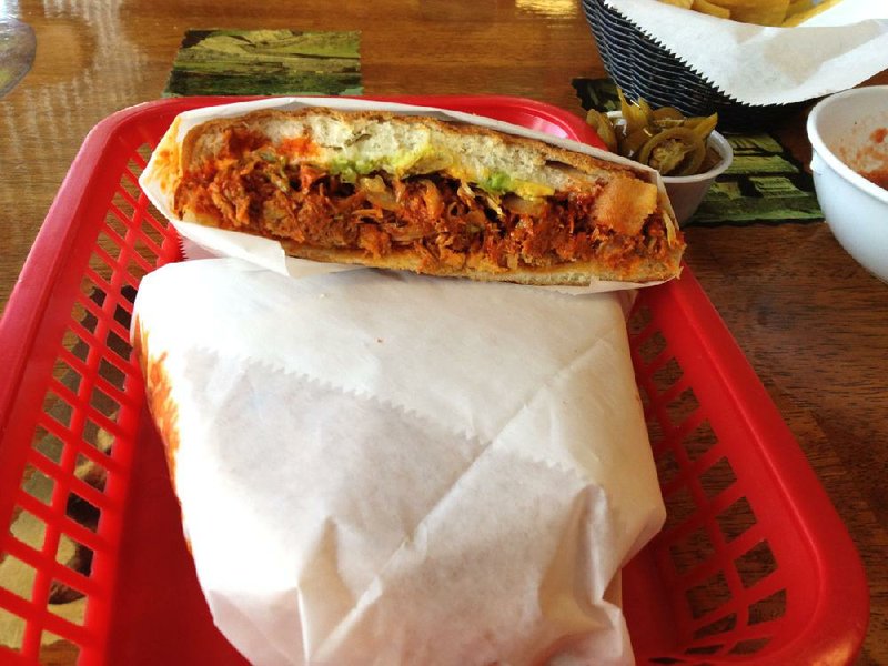 The Torta Pierna Enchilada at North Little Rock’s Tortas Mexico features shredded pork in a red sauce with lettuce, mayonnaise, tomatoes, onions, avocado and jalapeno peppers on an enormous bun.

