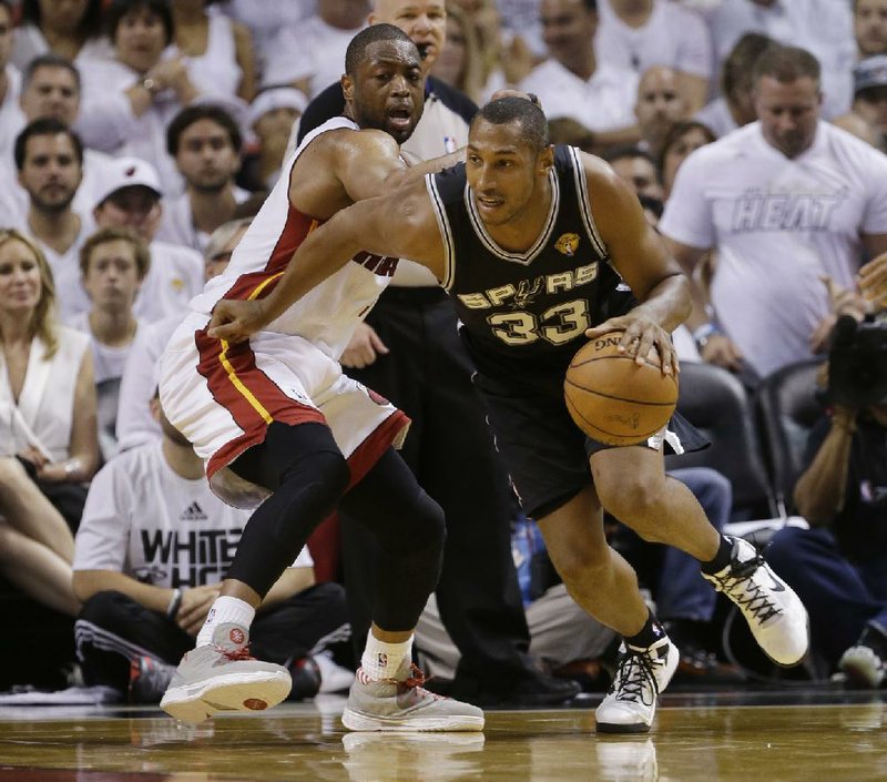 San Antonio forward Boris Diaw (33) drives around Miami’s Dwyane Wade in the second half of the Spurs’ 107-86 victory Thursday in Miami, which gave the Spurs a 3-1 lead in the NBA Finals.