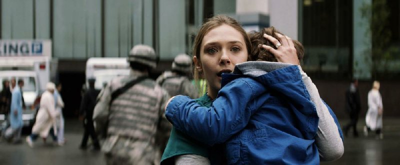 Elizabeth Olsen as Elle Brody and Carson Bolde as Sam Broday in Godzilla.