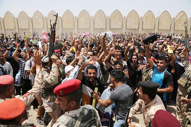 Iraqi men rally in Baghdad on Thursday against the Islamic State of Iraq and the Levant as they gather to volunteer for military service. Authorities have urged Iraqis to help battle the insurgents. 