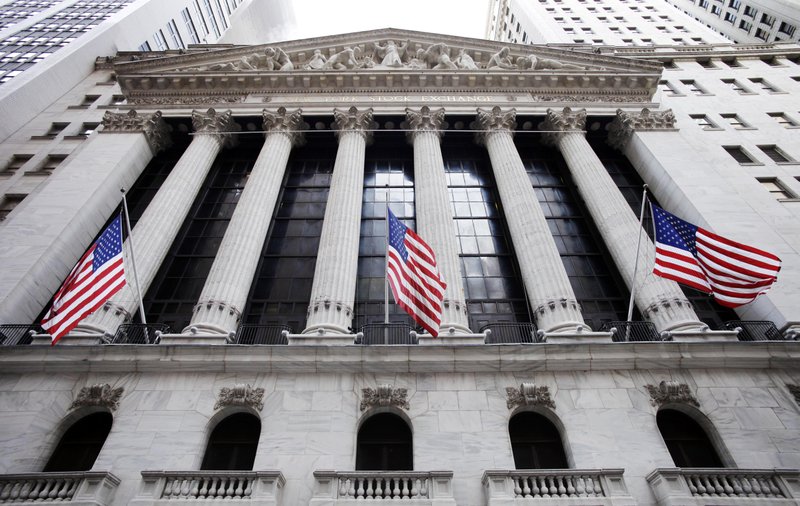 In this Feb. 10, 2011 file photo, American flags fly in front of the New York Stock Exchange, in New York. Asian stock markets fell for a second day Thursday June 12, 2014 and European shares drifted as a dimmer outlook for global growth this year gave investors a reason to lock in recent gains.