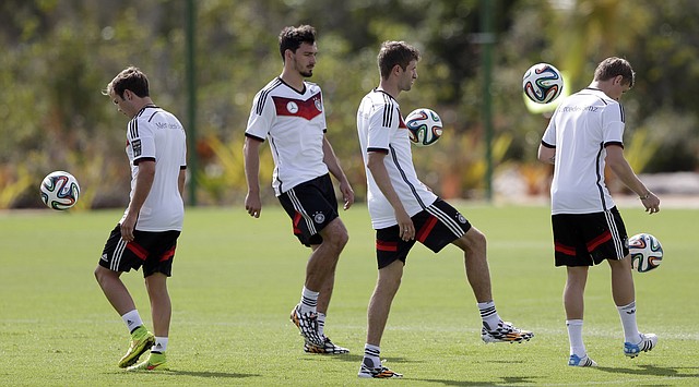German national soccer players Mario Goetze, from left, Mats Hummels, Thomas Mueller and Toni Kross joggle balls during a training session in Santo Andre near Porto Seguro, Brazil, Thursday, June 12, 2014. Germany will play in group G of the 2014 soccer World Cup.
