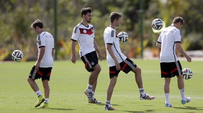 German national soccer players Mario Goetze, from left, Mats Hummels, Thomas Mueller and Toni Kross joggle balls during a training session in Santo Andre near Porto Seguro, Brazil, Thursday, June 12, 2014. Germany will play in group G of the 2014 soccer World Cup.