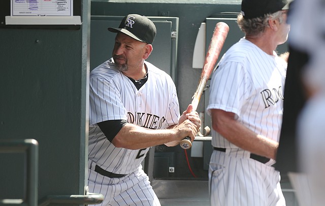 Upset after being ejected from the game, Colorado Rockies manager Walt Weiss takes a bat and smashes it into the wall by the batting rack in his team's dugout on his way to the showers against the Atlanta Braves in the eighth inning of the Rockies' 10-3 victory in a baseball game in Denver on Thursday, June 12, 2014. Weiss was upset over the Rockies' Corey Dickerson being hit by a pitch thrown by Braves relief pitcher David Carpenter.