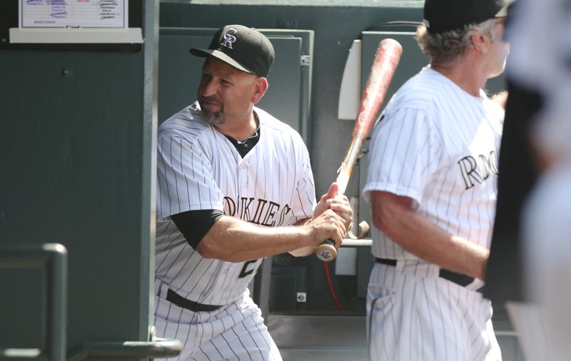 Upset after being ejected from the game, Colorado Rockies manager Walt Weiss takes a bat and smashes it into the wall by the batting rack in his team's dugout on his way to the showers against the Atlanta Braves in the eighth inning of the Rockies' 10-3 victory in a baseball game in Denver on Thursday, June 12, 2014. Weiss was upset over the Rockies' Corey Dickerson being hit by a pitch thrown by Braves relief pitcher David Carpenter.