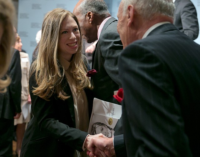 Hillary Clinton's daughter Chelsea shakes hands with a member of the audience after her mother  a participated in a conversation about her career in government and her new book, "Hard Choices.," at the Council on Foreign Relations, in New York, Thursday, June 12, 2014.