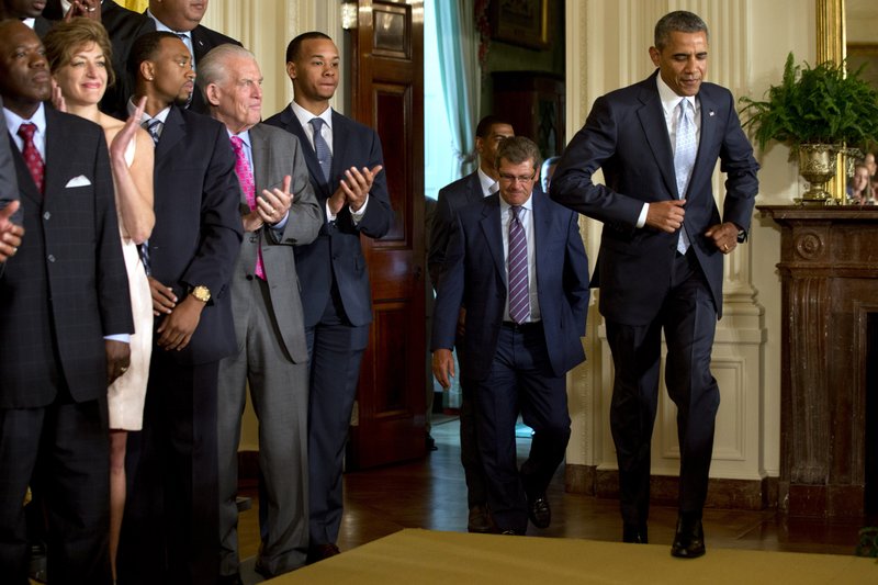 This June 9, 2014 file photo shows President Barack Obama jogging in to an event honoring the NCAA Basketball Champion UConn Huskies Men's and Women's Basketball teams, and their 2014 NCAA Championships in the East Room of the White House in Washington. The White House says President Barack Obama is in excellent health and will stay that way for the rest of his time in office. The White House on Thursday released a summary from Obamas doctor following the presidents physical exam last month. The report says Obama continues to make healthy lifestyle choices. He eats a healthy diet, exercises daily and remains tobacco-free. Obama is a former smoker.