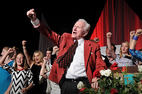 Frank Broyles, surrounded by his family, calls the hogs to close the evening during the 'Coach's Quarter: A Celebration of Coach Broyles' Life and Career' banquet at the John Q Hammons Center in Rogers on Saturday June 7, 2014.