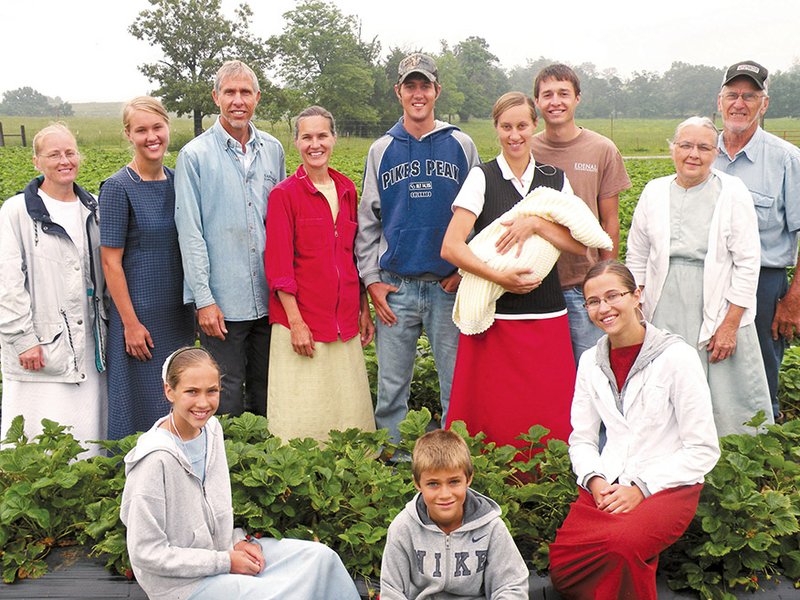 The Robert Byler family of Drasco has been named the 2014 Cleburne County Farm Family of the Year. Members of the family, shown here in their strawberry patch, are, front row, from left, Shauna, Timmy and Crystal Byler. In the back row are Katie Byler’s sister, “Little” Hannah Stoltzfus; Stephanie Byler; Robert Byler; Katie Byler; Kendal Byler; Carla Mast, holding baby Allison Rose; Lyndall Mast; and Katie Byler’s parents, “Big” Hannah Stoltzfus and Amos Stoltzfus.