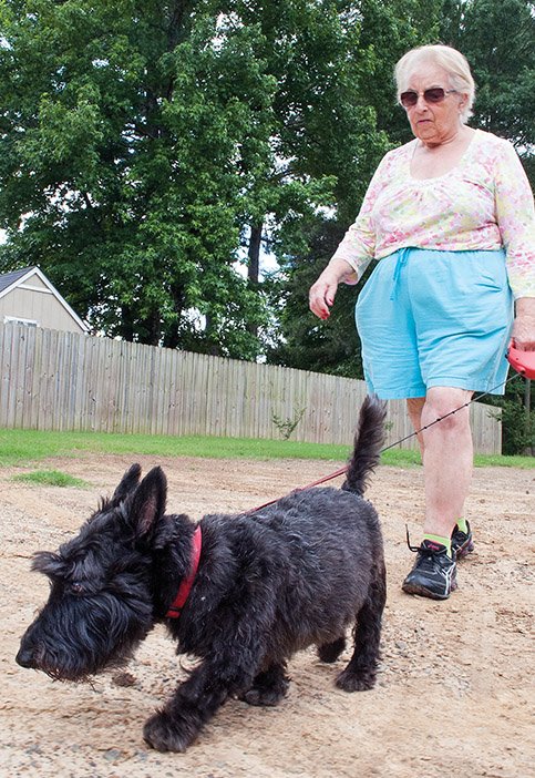 Barbara Moeller takes Barney, her Scottish terrier, for a stroll on the Tucker Creek Walking/Bike Trail in Conway. The Conway City Council on Tuesday approved allocating $25,000 from Advertising and Promotion Commission funds to match $25,000 the city won in an online contest in 2013. Conway’s first dog park will be built on almost 4 acres at the Don Owen Recreation Complex on Lower Ridge Road.