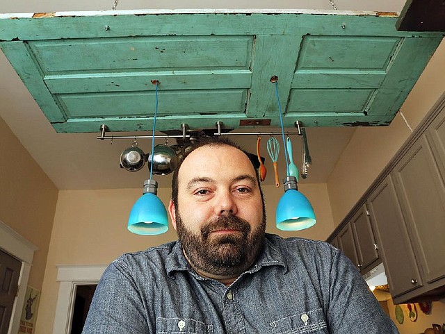 Arkansas Democrat-Gazette/JOHN SYKES JR. - Matt Bell, chef at South on Main, in his home kitchen, beneath a door used to hang kitchen paraphernalia.