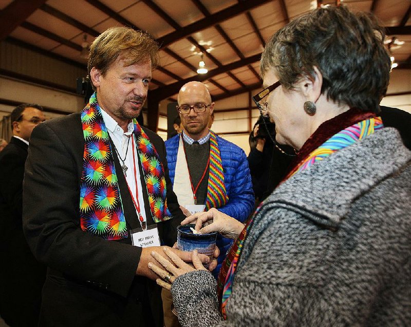 The Rev. Frank Schaefer, left, of Lebanon Pa., celebrates communion with supporters after the sentencing phase of the trial at Camp Innabah, a United Methodist retreat, in Spring City Pa. Tuesday Nov. 19, 2013. A jury of his pastoral peers convicted Schaefer on Monday of breaking his vows by officiating his gay sons' Massachusetts wedding in 2007. Schaefer was given a 30 day suspension by the church.