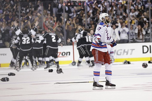 New York Rangers left wing Benoit Pouliot looks on after losing to the Los Angeles Kings during overtime in Game 5 of the NHL Stanley Cup Final series Friday, June 13, 2014, in Los Angeles. (AP Photo/Gregory Bull)