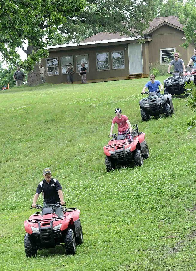 STAFF PHOTO FLIP PUTTHOFF Jack Ward, founder and CEO of Rugged Faith Ministries, leads riders out on ATVs at Rugged Faith Ranch.