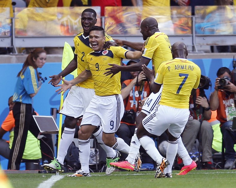 Colombia's Teofilo Gutierrez, centre, celebrates after scoring his side's second goal during the group C World Cup soccer match between Colombia and Greece at the Mineirao Stadium in Belo Horizonte, Brazil, Saturday, June 14, 2014.
