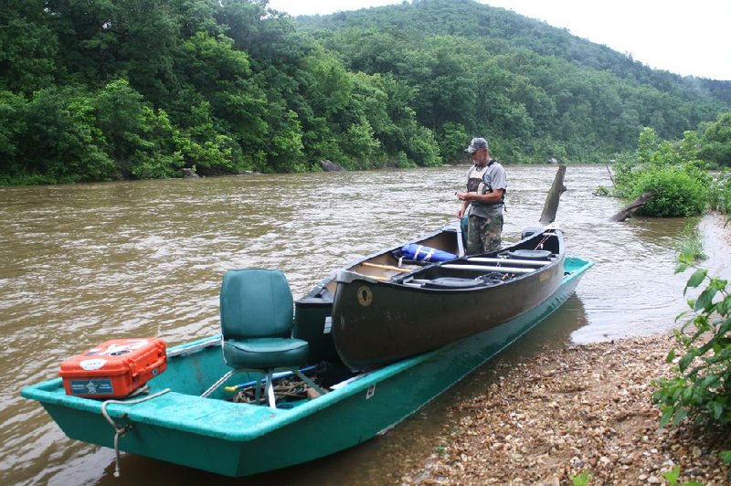 Ron Grinder prepares for the journey downstream after recovering two lost canoes on the Buffalo River near St. Joe.