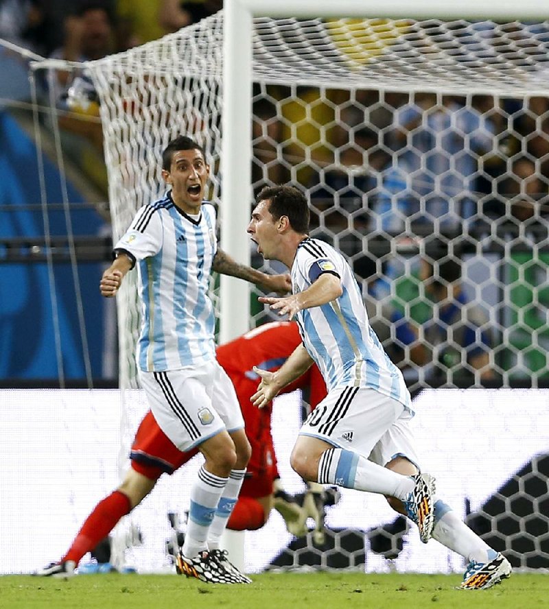Argentina’s Lionel Messi (right) celebrates with teammate Angel di Maria after he scored a goal Sunday against Bosnia-Herzegovina in a Group F World Cup match in Rio de Janeiro.