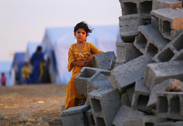 An Iraqi girl from Mosul stands outside her family’s tent at the Khazir refugee camp outside Irbil, Iraq. Iraqis are already being lured back to Mosul by insurgents.