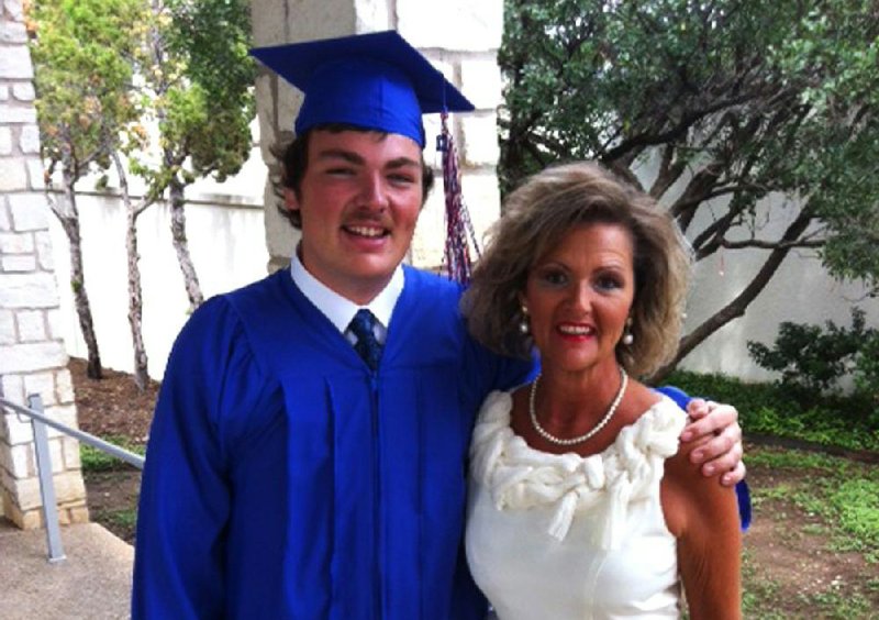 Chandler Thomas poses with his mother, Lisa Thomas, at his high school graduation.