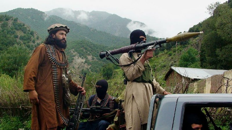 Pakistani Taliban patrol in their stronghold of Shawal in the Pakistani tribal region of South Waziristan in this file photo from Aug. 5, 2012.