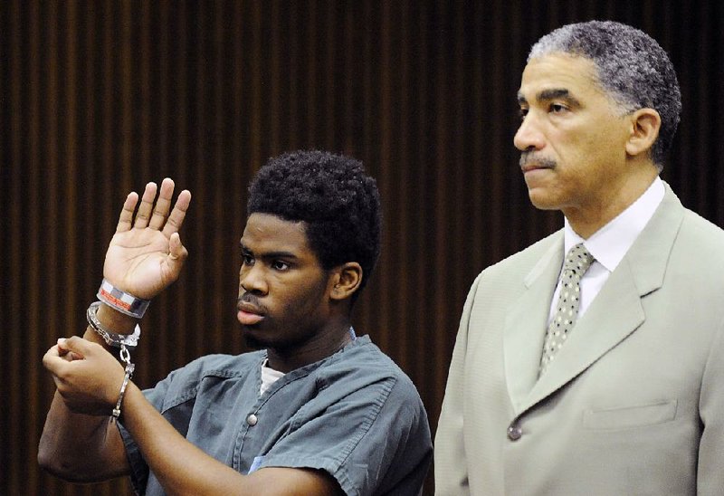 Defendant Bruce Wimbush Jr., standing with his defense attorney Randall Upshaw, pleads guilty in a mob beating at a hearing before Judge James Callahan at Frank Murphy Hall of Justice in Detroit on Monday.