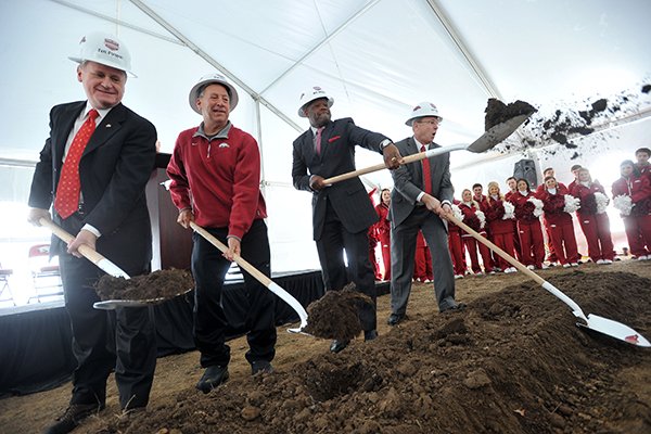 University of Arkansas chancellor G. David Gearhart, former women's head basketball coach Tom Collen, men's head basketball coach Mike Anderson and athletics director Jeff Long throw dirt during the official groundbreaking for the new Razorback Basketball Performance Center Saturday, Dec. 7, 2013 in Fayetteville. The 66,000 square foot facility is one of three new facilities for athletes being built on the campus, funded in part by financial donations to the Razorback Foundation.