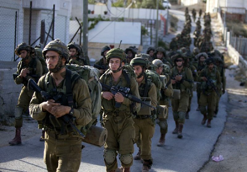 Israeli soldiers search for three missing teenagers during a military operation Tuesday in the West Bank city of Hebron.