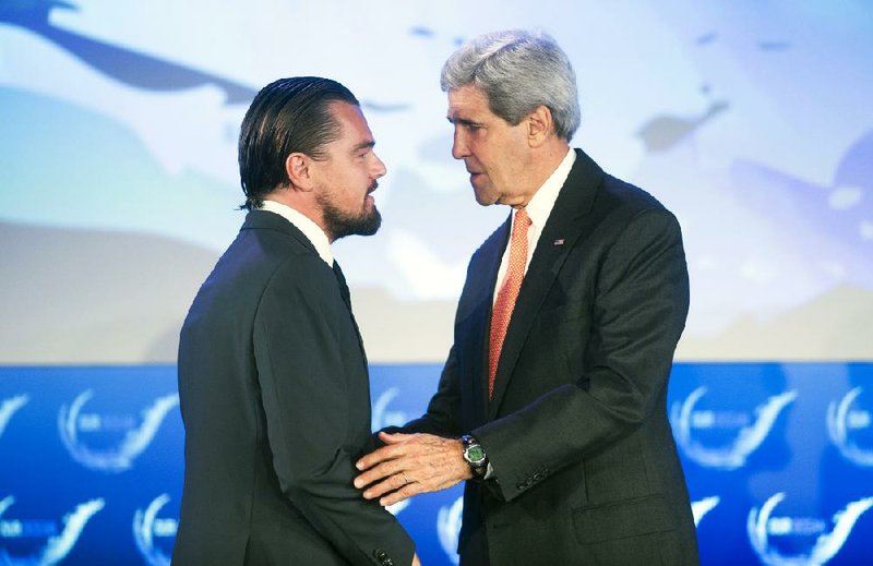 Secretary of State John Kerry talks Tuesday with actor Leonardo DiCaprio after they both spoke on the second day of the State Department’s oceans conference in Washington.