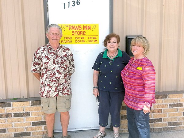 Paws Inn No Kill Animal Shelter members, from left, Treasurer Tom Slough, Vice President Ruth Lacey and President Sandra Briggs are shown at their new location, where they have more space for the organization’s mini flea market.
