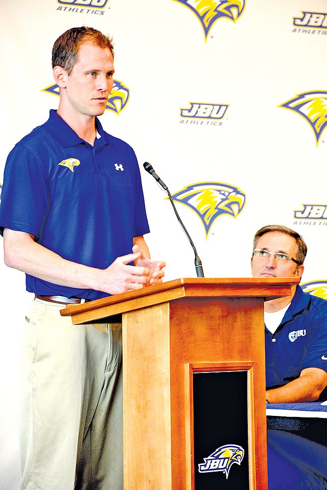 Staff Phoot Graham Thomas Jason Beschta, new John Brown University men&#8217;s basketball coach, speaks during a news conference Tuesday as JBU Vice President of Student Development Dr. Steve Beers, right, looks on at the Simmons Great Hall on the campus of JBU.