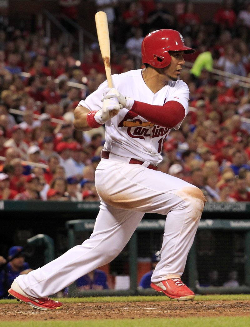St. Louis Cardinals' Jon Jay watches his RBI triple during the fifth inning of a baseball game against the New York Mets Tuesday, June 17, 2014, in St. Louis.